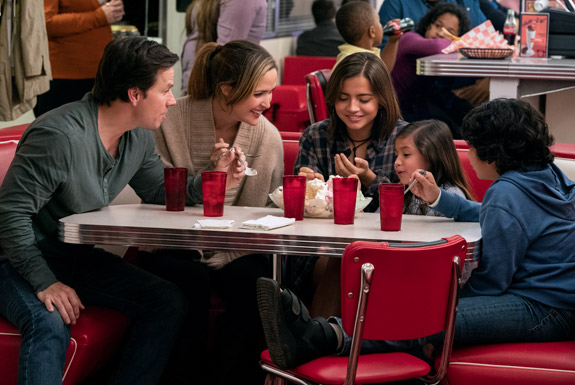 Mark Wahlberg, Rose Byrne and three children they adopt eating at a diner.